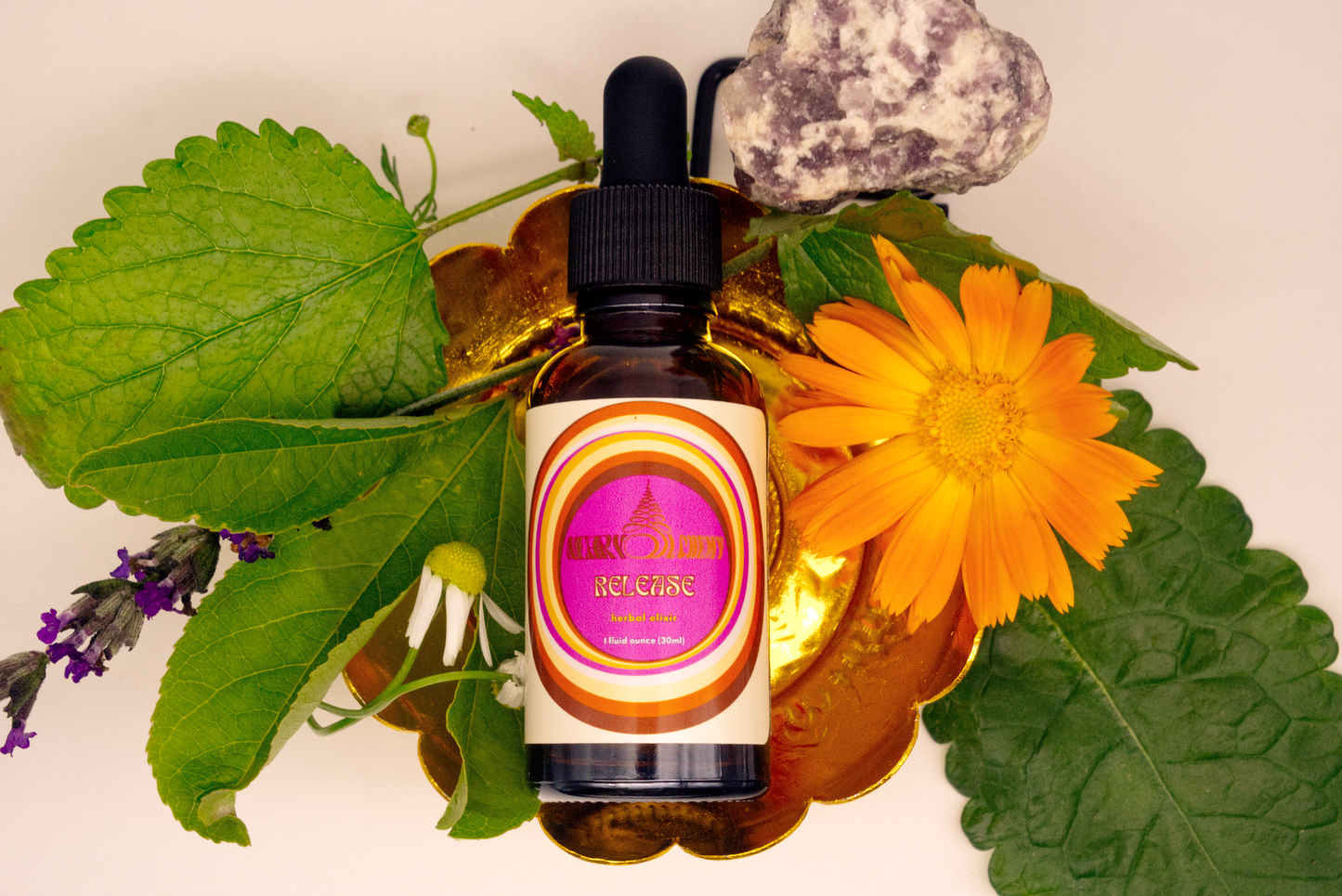 Bottle of natural product with a dropper surrounded by leaves and flowers on a white background