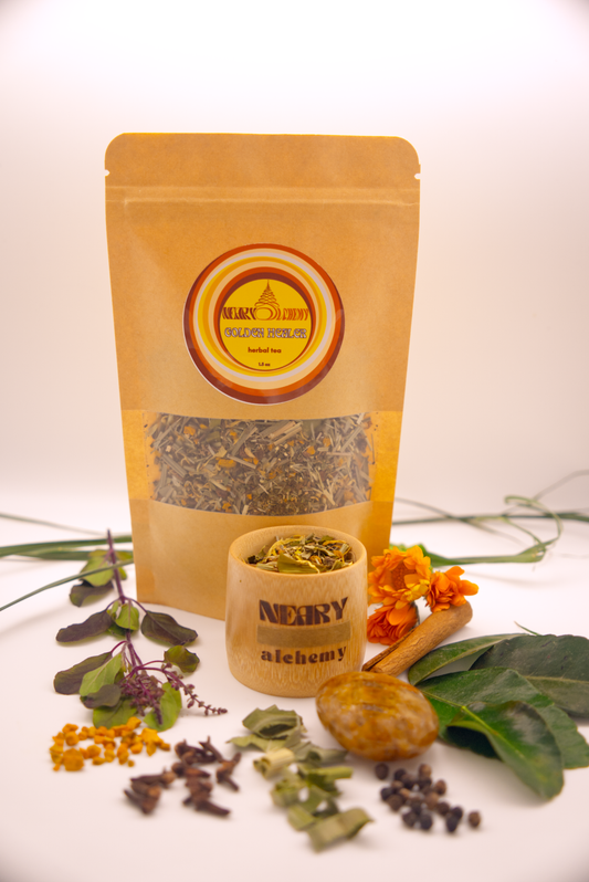 Golden Healer Tea package surrounded by tulsi, turmeric, Golden Healer Crystal, Makrut lime leaf and other herbs.